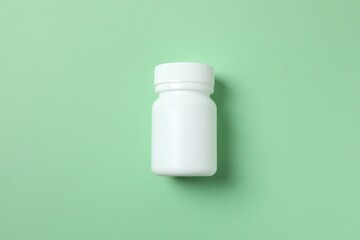 White bottle on a green background