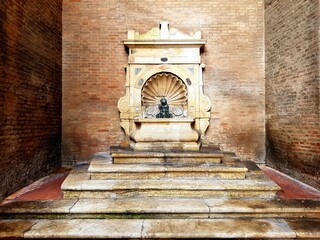 Naklejka premium old marble fountain in the interior of the castle of Rimini, Italy