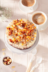 Sweet cheesecake with walnuts served on cake stand.