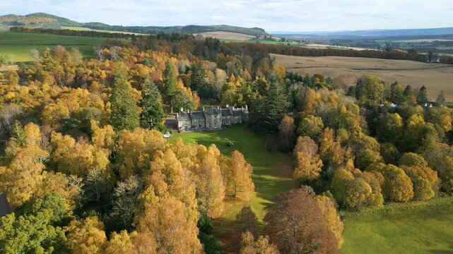 helicopter parked grass luxurious country house estate autumn trees forest background enhance visual appeal property circling aerial drone shot hotel mansion 