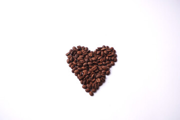 Coffee beans arranged in a heart shape on a white background, symbolizing love for coffee and warm, aromatic mornings. Valentines Day 