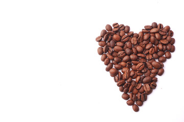 A heart shape made of roasted coffee beans positioned on a white surface, symbolizing passion for coffee and its energizing aroma, often associated with love, comfort, and daily indulgence.