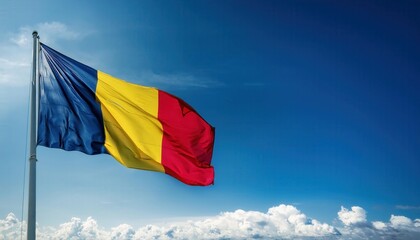 Waving proudly against a backdrop of clear blue sky, the Romanian flag flutters on a pole, symbolizing national identity and unity. This vibrant display represents the spirit of the country