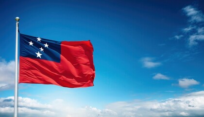 A striking flag of Samoa flutters confidently on a pole under an expansive blue sky, symbolizing national pride