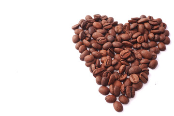 Roasted coffee beans are artistically arranged into a heart shape on a white background,...
