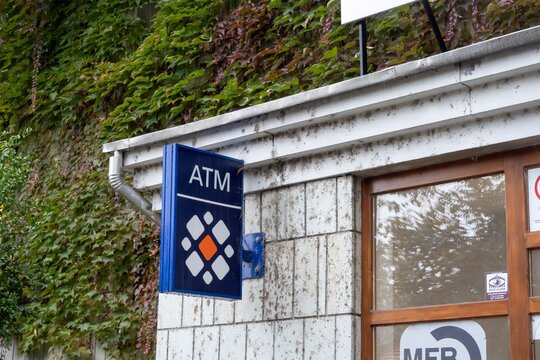 Banner and sign of ATM for Takarek Bank in Tokaj, Hungary