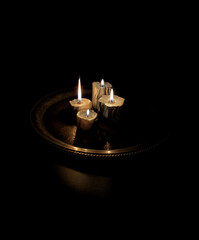 Dimly Lit Candlelight on Old Metal Tray
