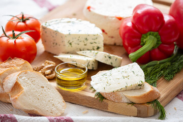 Home organic cheese with crispy bread, tomatoes, pepper, olive oil and walnut.