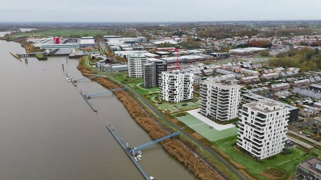new development area de zaat temse belgium scene includes riverside apartments historic boelwerf crane scheldt river forward aerial drone shot view cordeel headquarters 