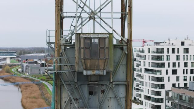 historic boelwerf crane operator cabin temse belgium scene riverside apartments scheldt river background backward aerial drone shot view 
