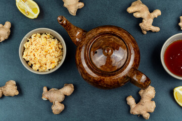 Ginger tea with limes in a glass teapot.