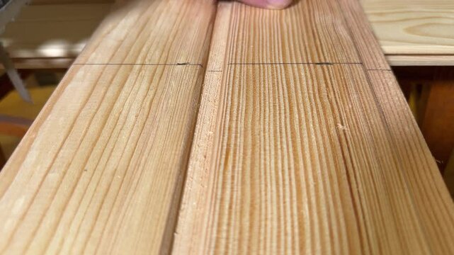 Sawing of wooden planks with jigsaw along the marking line