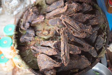 Full pile of spiced buffalo beef jerky snack smoked at traditional restaurant of ethnic people in Mai Chau, Hoa Binh, Vietnam, dried barbeque wooden fire cooking, travel destination experience
