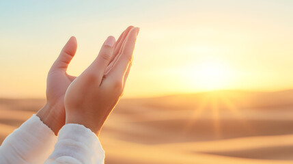 A symbolic image of hands lifted towards the glowing horizon in a tranquil desert setting, representing faith, prayer, and new beginnings, good for religious or motivational visuals. Selective focus