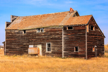 A large, old, wooden house with a slanted roof