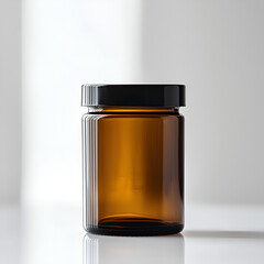 Amber glass jar with black lid on white background. Perfect for essential oils, medication, or other products.