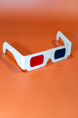 3D glasses on orange background. 