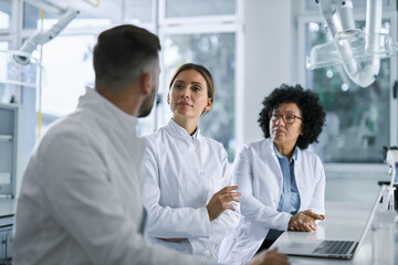 Medical experts talking while working on medical research in laboratory