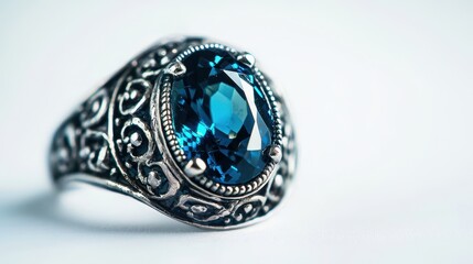 A close-up of an elegant silver ring with a large gemstone, placed on a white isolated background