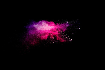 Explosion of pink colored powder isolated on black background.Pink dust splash.