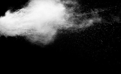 White powder explosion isolated on black background.White dust particles splash.