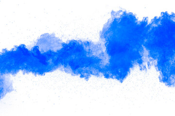 Abstract blue powder explosion on white background. Closeup of blue dust particles splash isolated on clear background.