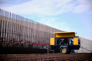 Mobile air compressor at construction site