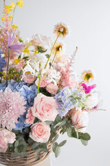 Beautiful floral arrangement for Valentine's Day and International Women's Day featuring pink roses, blue hydrangeas, seasonal blooms, and delicate accents