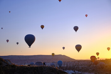 Colorful hot air balloons. Sunrise at Cappadocia. Bright colorful ballons flying during sunrise in valley. Goreme, Nevsehir, Cappadocia
