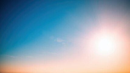 A vibrant blue sky at sunset with a bright sun casting a warm glow, creating a serene and tranquil atmosphere.