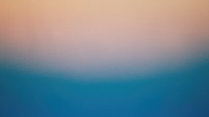 Fototapeta premium A smooth gradient transitioning from soft peach to tranquil blue tones, evoking a peaceful atmosphere and a sense of calm.