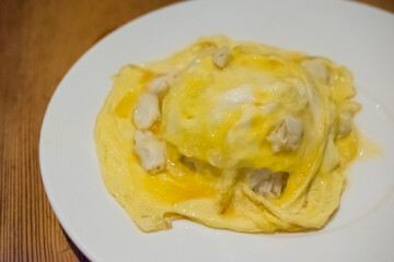 Omelette with crab served on plate
