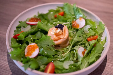 Parma salad with caviar and ikura, a dish combining savory Parma ham, delicate fish roe, and fresh...