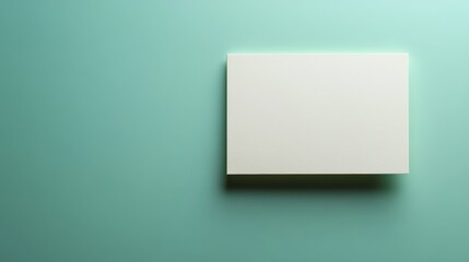 Fototapeta premium A plain light-green postcard is placed on a matching light-green background, showcasing a minimalistic design