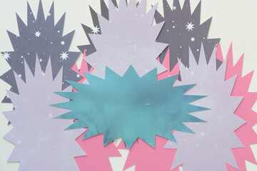 layered machine-cut paper shapes with starburst effect on blank paper