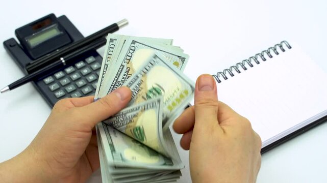 Female accountant counting US dollars 100 dollars