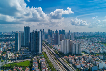 Naklejka premium Urban skyline reflecting in calm water during late afternoon with clouds in the sky