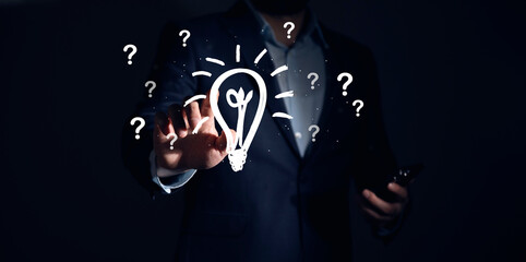 hand holding light bulb with question mark