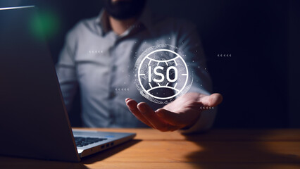 businessman holding a iso icon with computer