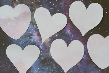 machine-cut paper hearts on scrapbooking paper with astronomy theme