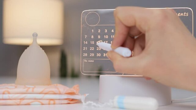 A user interacts with a modern menstrual tracking device featuring a holographic calendar while hygiene products are neatly arranged nearby. The stylish setup enhances usability and aesthetics