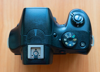 Exploring the features of a digital camera on wooden surface
