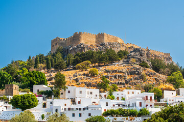 White traditional Greek village at the foot of the Acropolis of Lindos on the island of Rhodes. The...