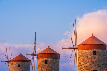 A view of the harbor of the Greek island of Rhodes with ancient windmills and yachts in the...