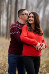 Fototapeta premium Expecting couple in nature with blurred background