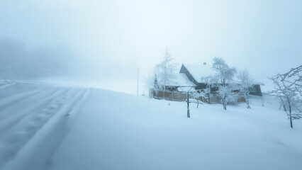 Mountain wooden house in winter scenery and fog in a dreamy mood