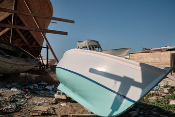 Craft shipyard. Hulls of yachts at wharf under construction. Low angle view of yacht frame on a...