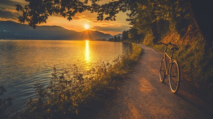 Fototapeta premium Sunset bike ride, lakeside path, mountain view