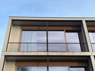Minimalist office, concrete walls and floor-to-ceiling windows