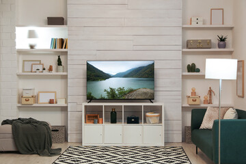 TV set with nature landscape on screen in room